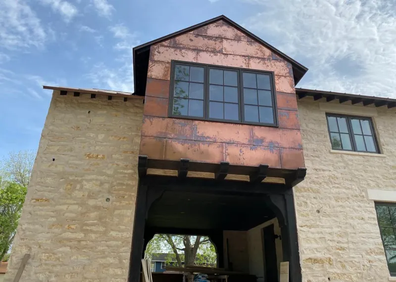Copper metal panel facade on a stone building for Metal Roof Coating in Pampa