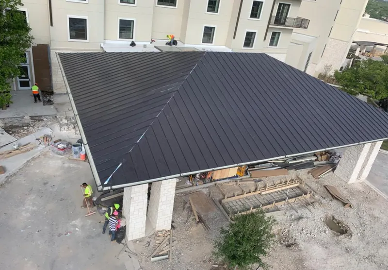 Metal roofing installation team working on a commercial building in Pampa