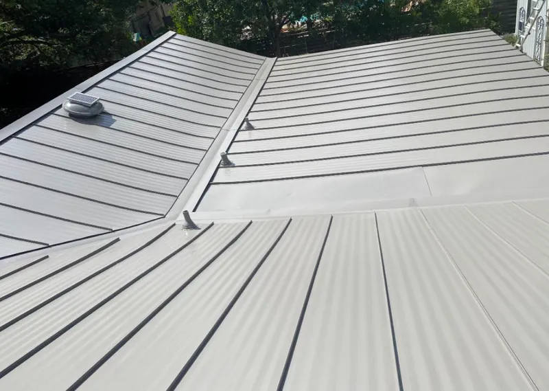 Solar attic fan installed on a metal roof for Roof Ventilation in Pampa